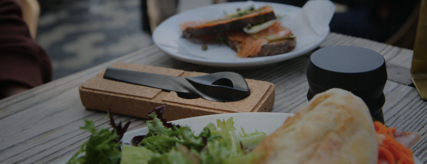 Weed pipe and grinder on a table with food