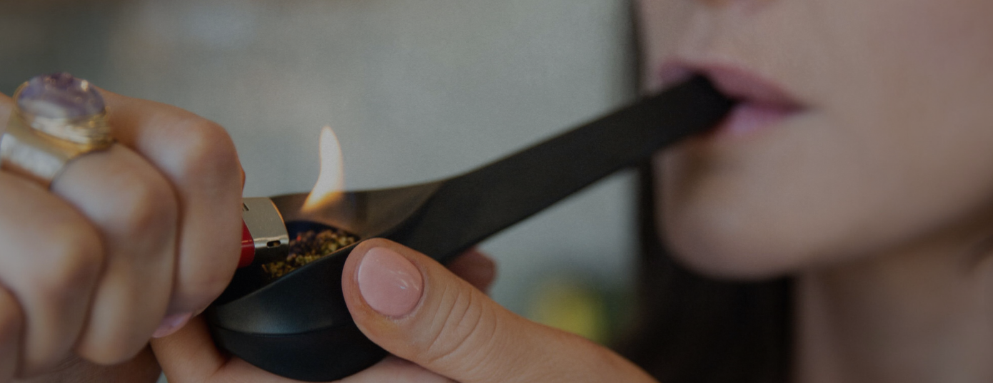 woman cornering weed in pipe