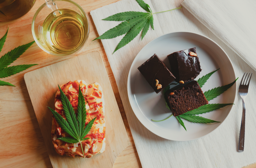 edible brownies, pizza and cannabis tea on a table