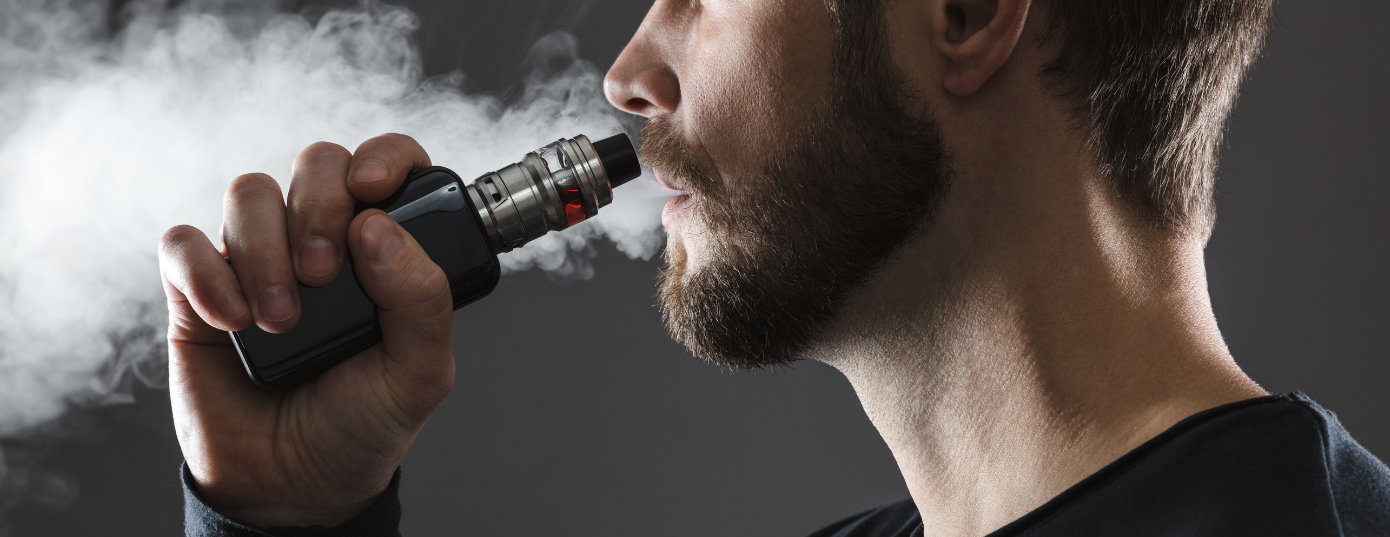 man with vape pen on hand