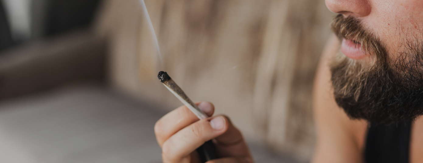 man smoking a weed joint