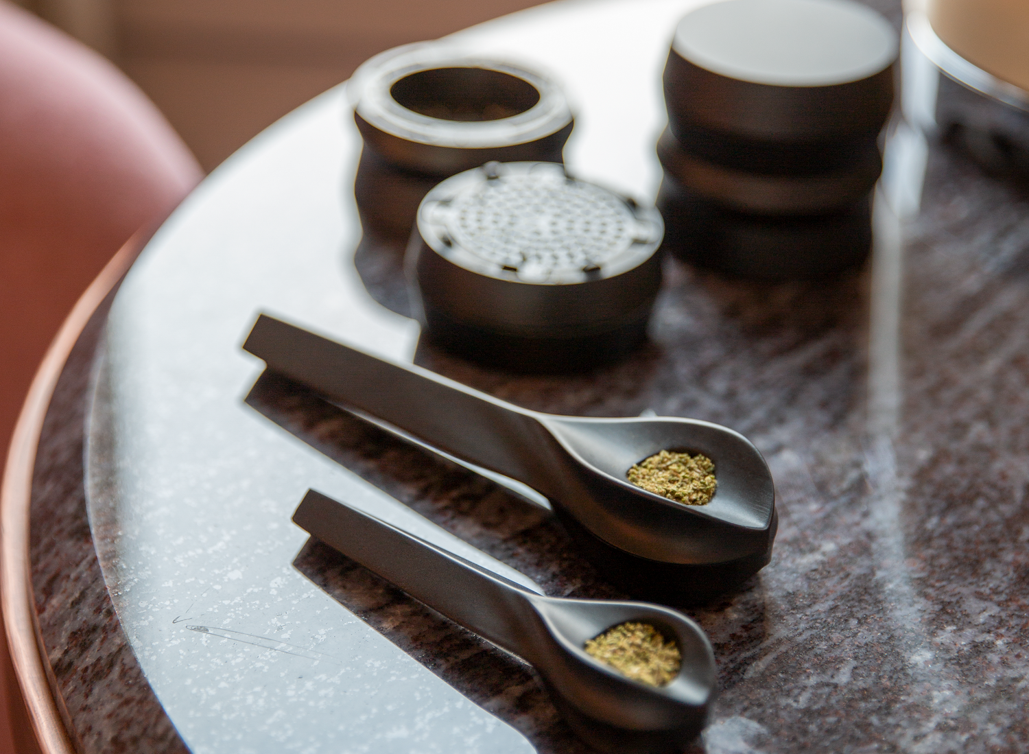 Two bowls packed full of weed near a grinder