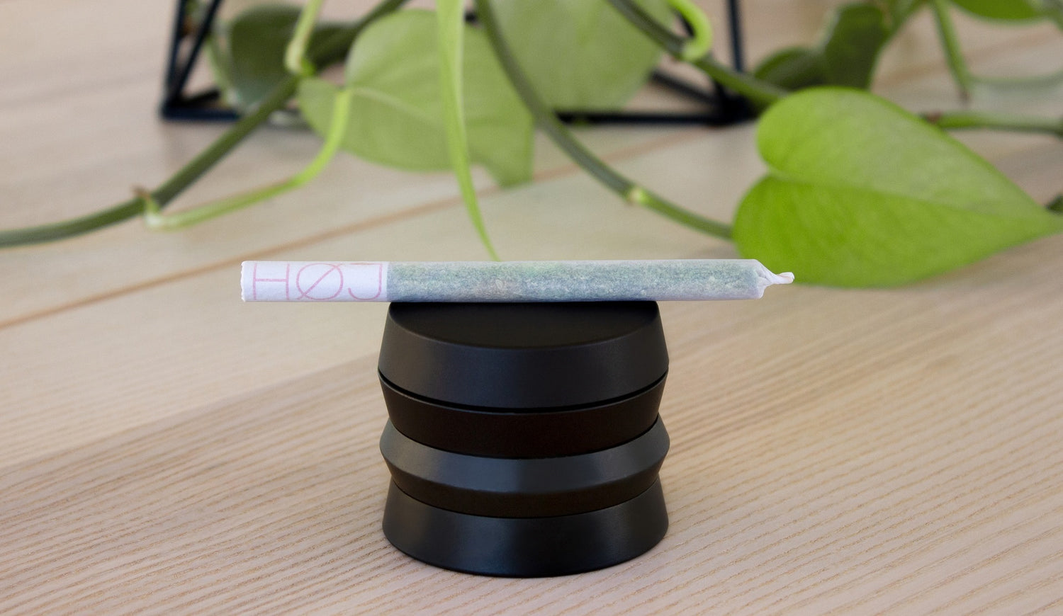 A fancy joint laying on a weed grinder