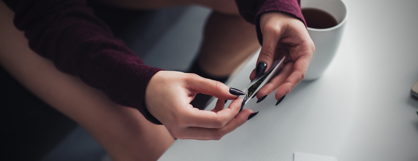 woman hands rolling a blunt