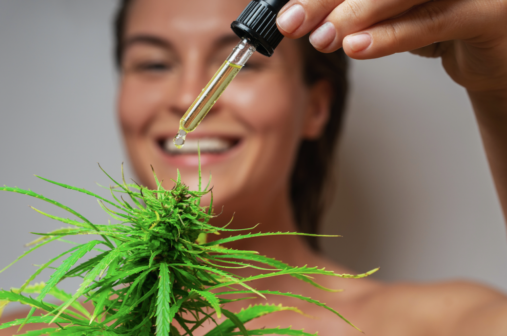 Woman with THCa oil concentrate with cannabis plant