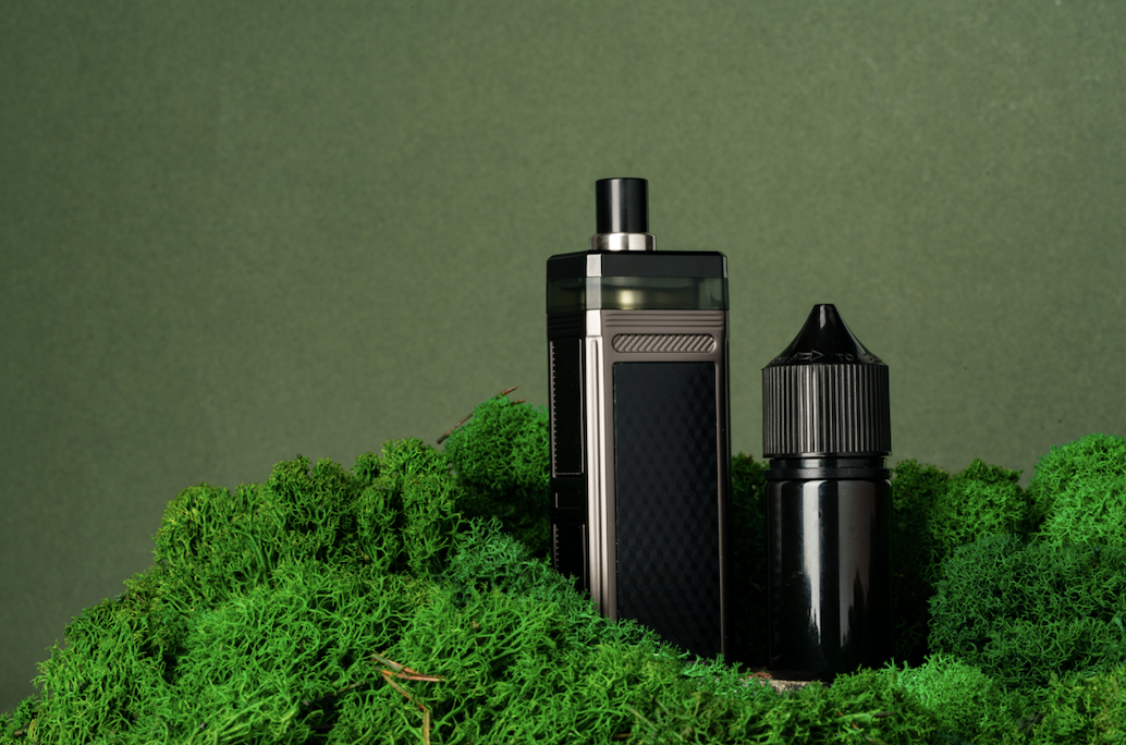 vapes in a green glass display