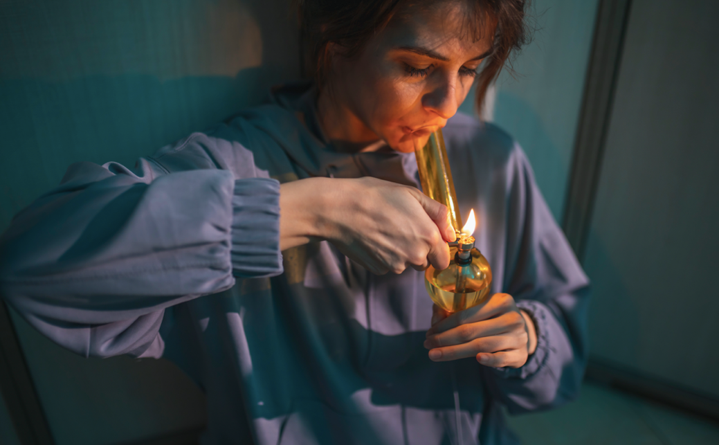 Woman smoking a bong for the first time