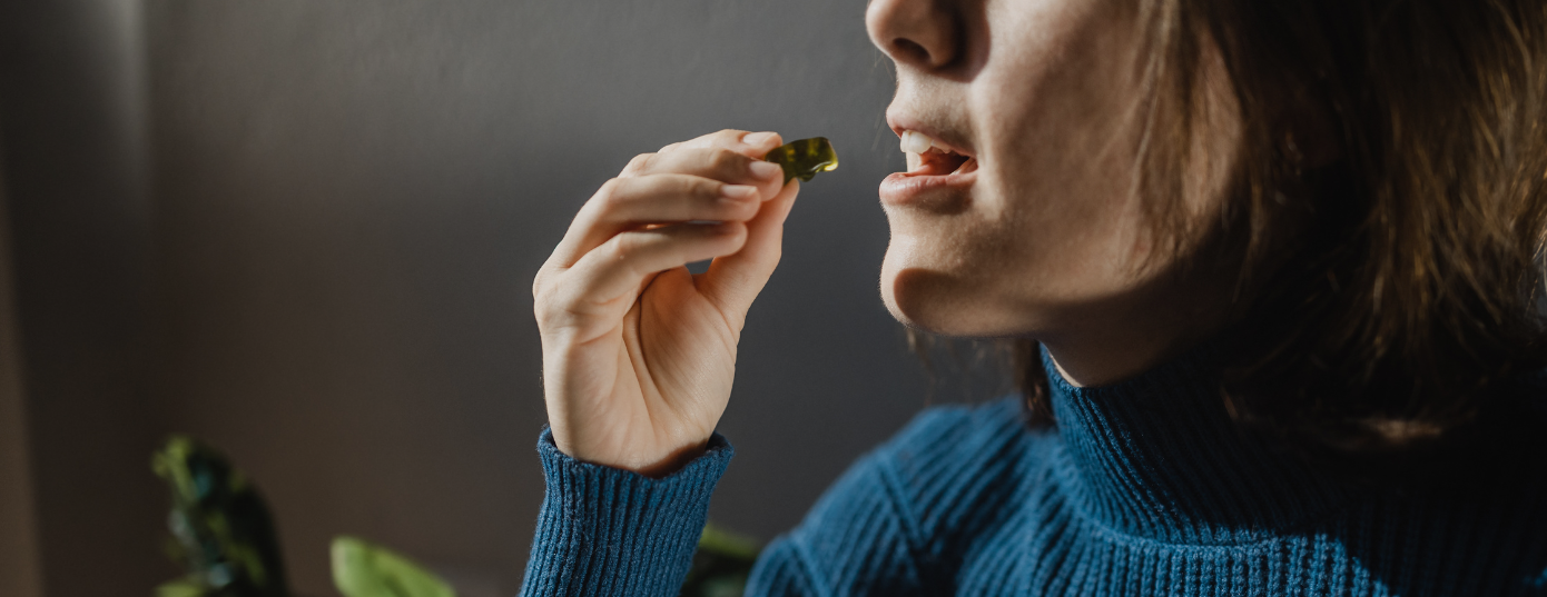 woman eating a delta 8 gummy