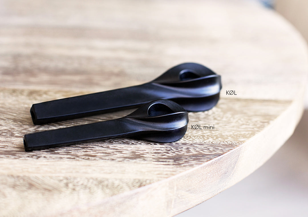 KOL pipe and KOL mini pipe over a wooden table
