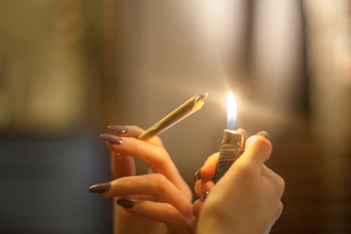 A perfectly preserved joint is held to the flame of a lighter