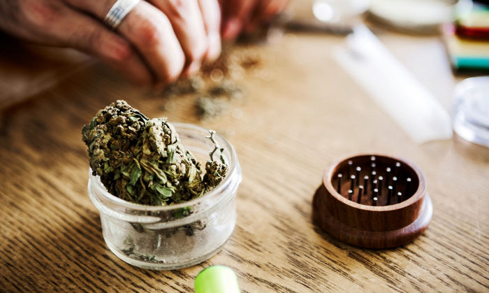 User getting ready to roll a joint with a pen