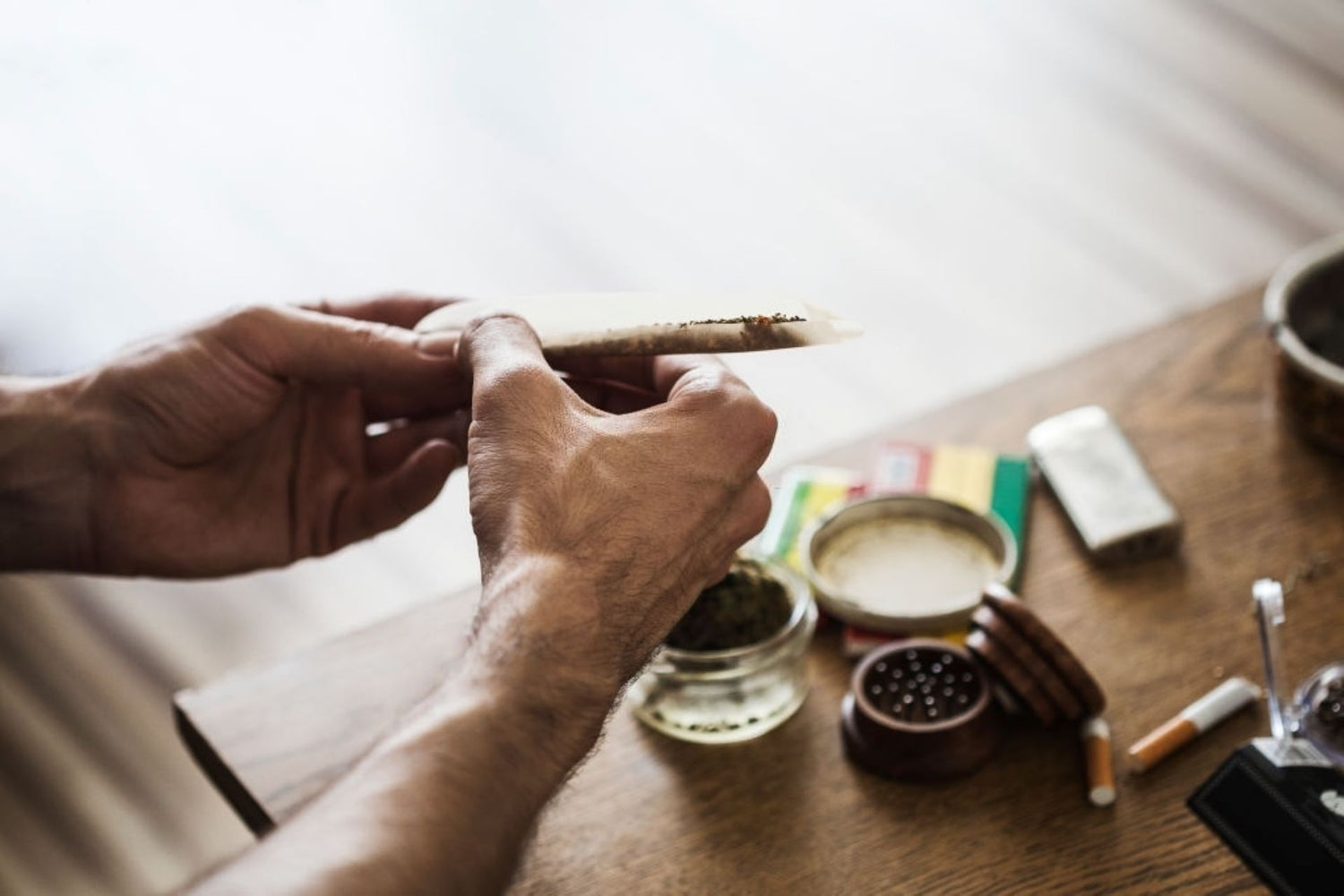 Man rolling a peace sign joint filter 