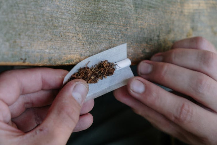 Hands rolling an european joint