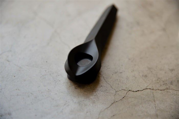 A beautiful black KØL Pipe sits on a clean cement countertop 