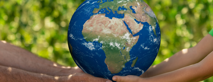 hands holding a planet Earth
