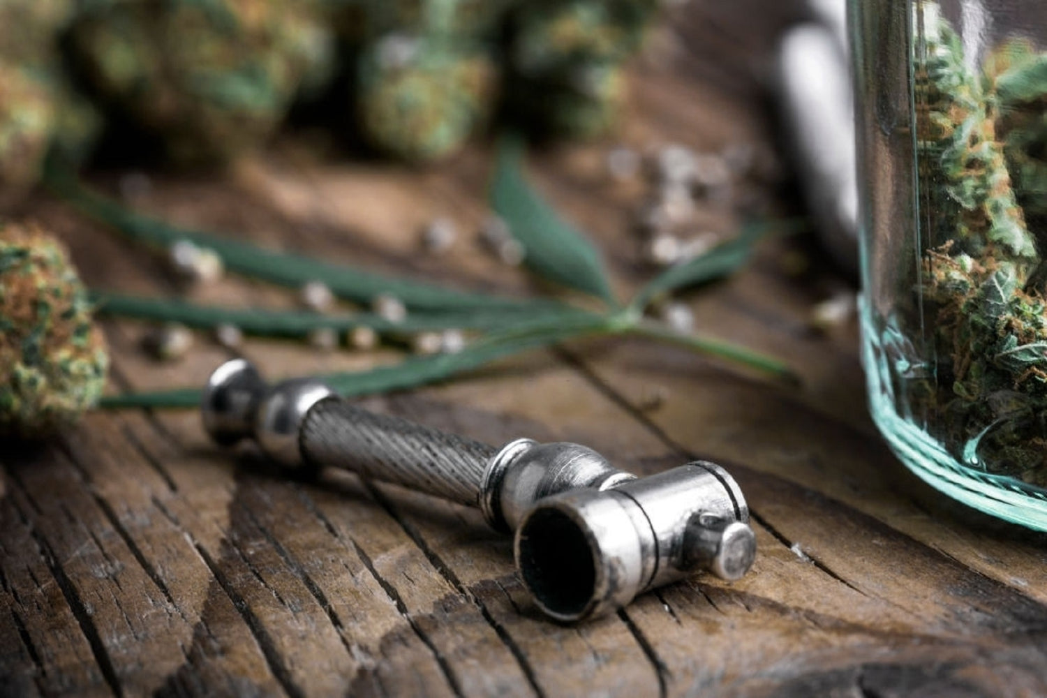 Brass pipe next to cannabis nugs