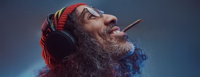 man listening to jazz music with headphones and smoking weed