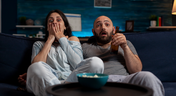 Scared couple watching a spooky movie