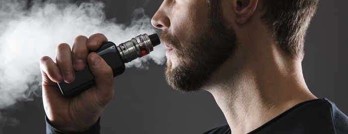 man with vape pen on hand