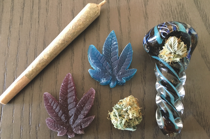 glass pipe with cannabis, edible gummies and a joint