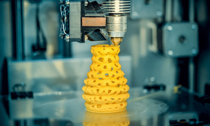 A 3D printer creates a beautiful yellow vase