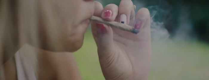 blong girl smoking a joint outdoors