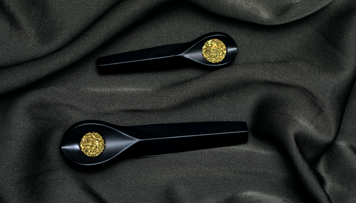 KOL pipes with cannabis over black background