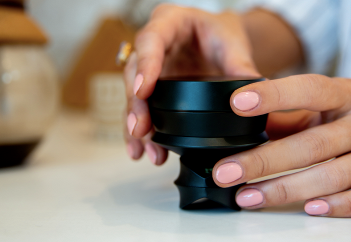 Hand holding KLIP grinder with funnel and KOL pipe