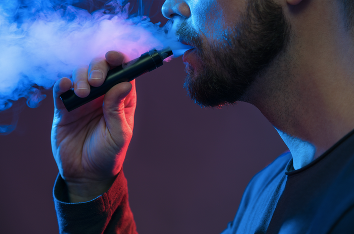 man smoking a vape