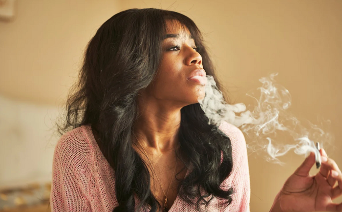 A black woman smokes weed without coughing