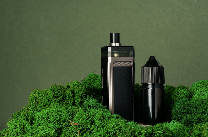 vapes in a green glass display