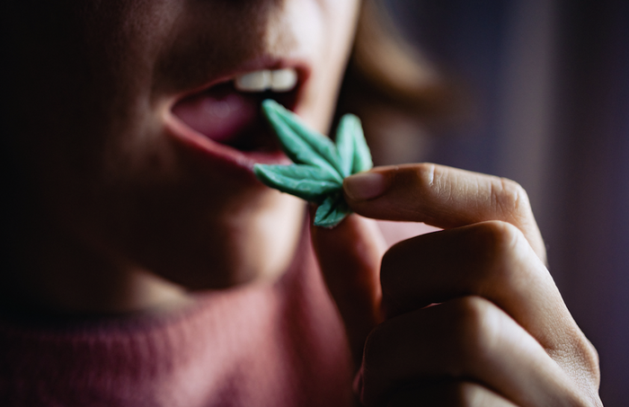 Woman eating a cannabis edible gummy