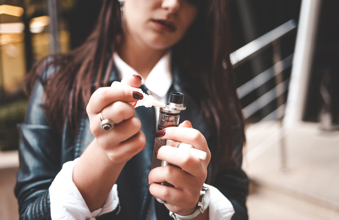 Woman filling her vape with vape juice