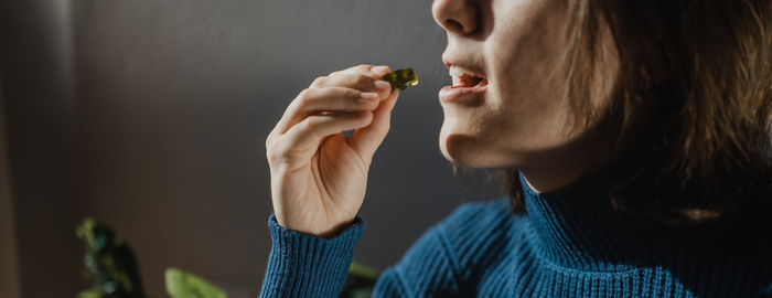 woman eating a delta 8 gummy
